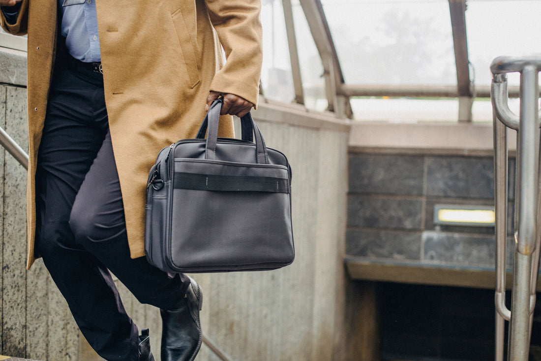 Businessman carrying a structured briefcase down city steps