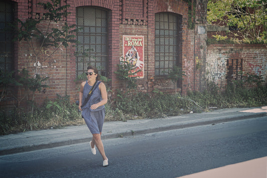 Traveler wearing a crossbody bag while walking a city street