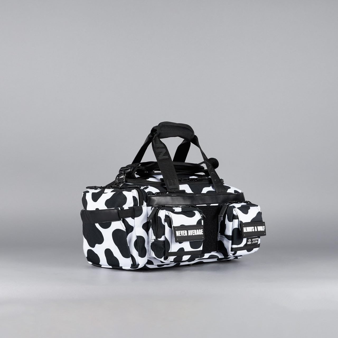 WOLFpak 20L Mini Duffle Bag for Gym & Travel | Waterproof Carry-On Weekender Bag with Shoe Compartment, Hard Bottom, and Tactical Molle System (Black & White Cow)